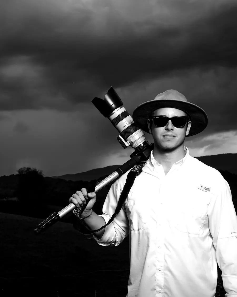 Austin Marvel with a cinema camera under a storm sky